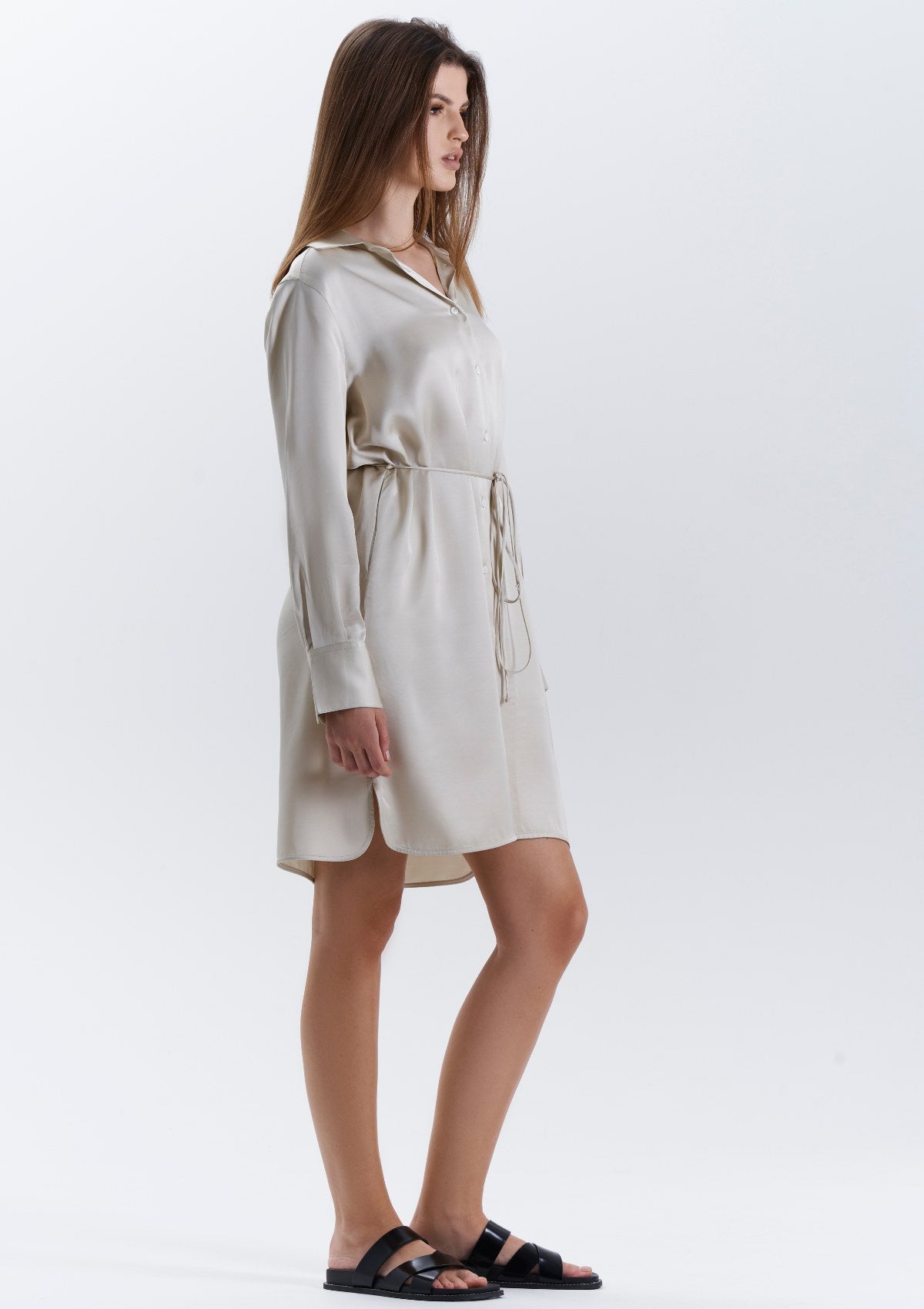 A versatile beige shirt dress that can be worn from day to evening.