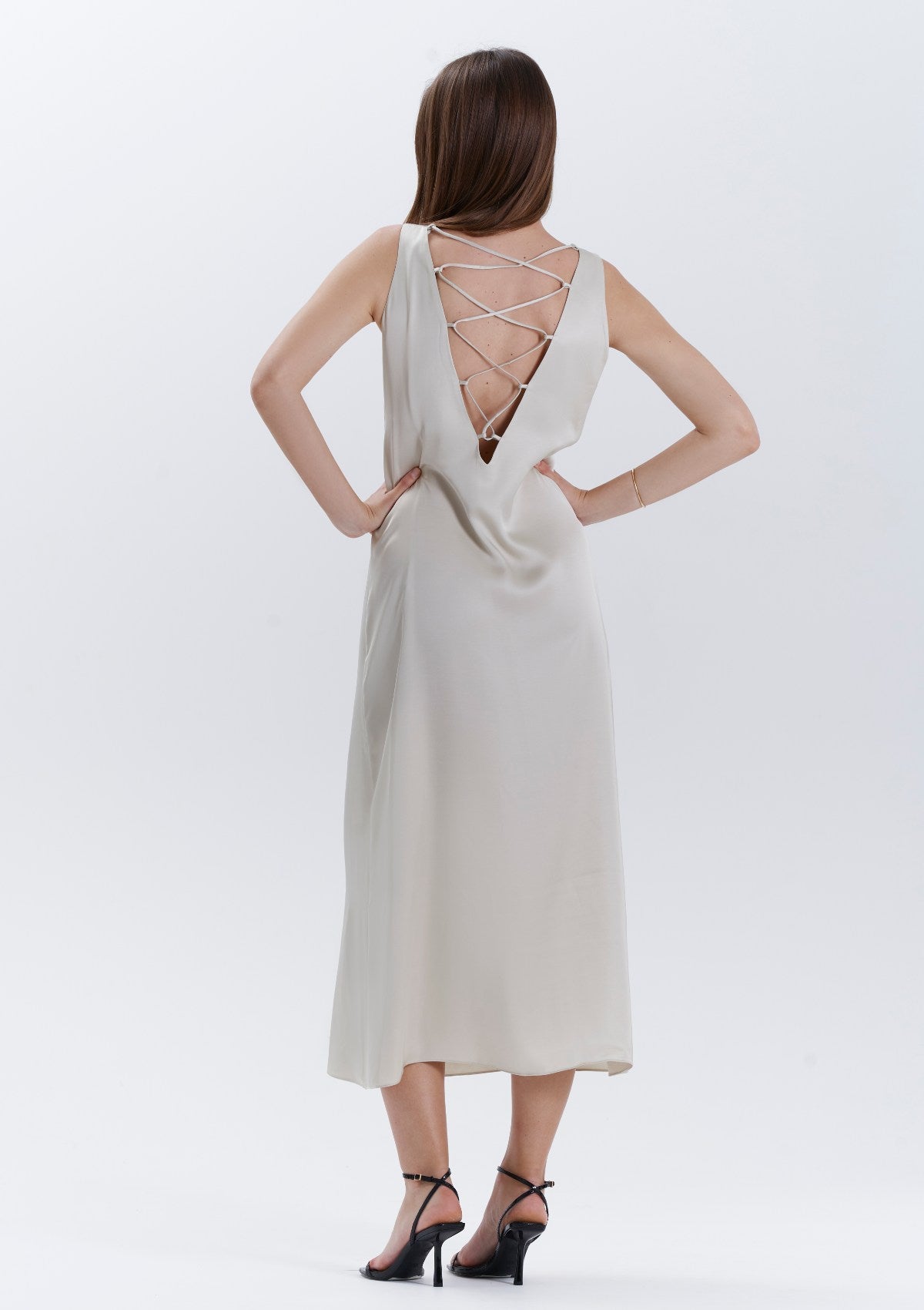 An evening beige dress with a multi straps low back